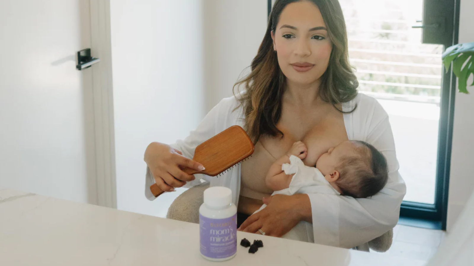 Breastfeeding mom nursing her baby at home with lactation supplements