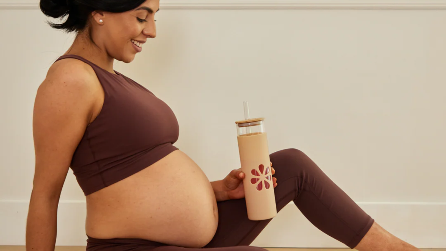 Expecting mother drinking a hydration beverage with electrolyte.