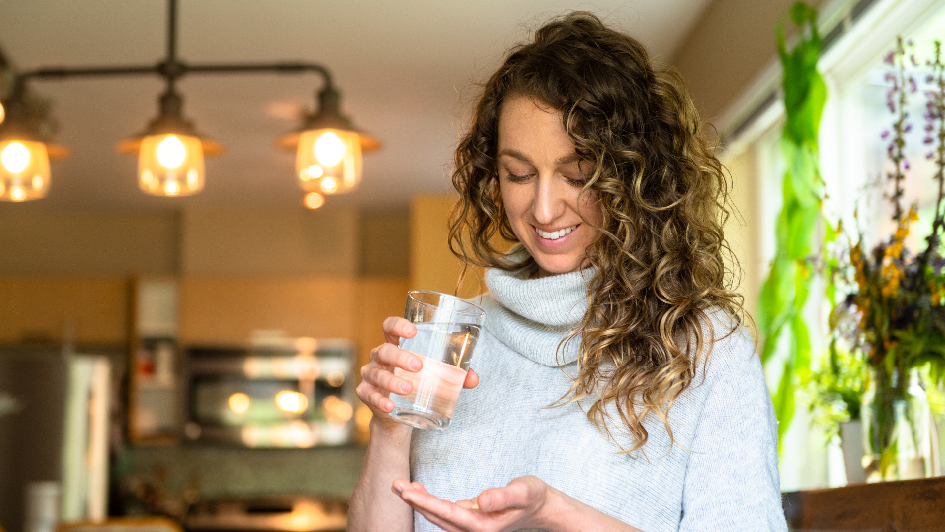 Woman taking daily supplements as part of her routine