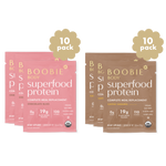 Two packages of Boobie Body Superfood Protein, one pink and one brown, on a white background.