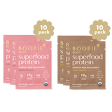 Two packages of Boobie Body Superfood Protein, one pink and one brown, on a white background.