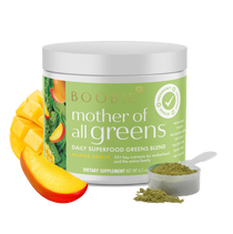 Boobie Mother of All Greens dietary supplement jar with mango slices and scoop on a white background
