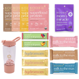 Assorted Boobie* Superfoods products including protein packages, gummies, and bars on a white background.