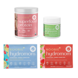 Boobie Superfood Protein, Mother of All Greens, Hydromom Hydration + Energy Drink Mix packaging on a white background