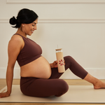 Glass Tumbler With Straw being held by a woman doing yoga