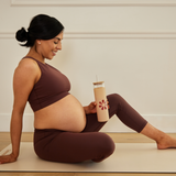 Glass Tumbler With Straw being held by a woman doing yoga
