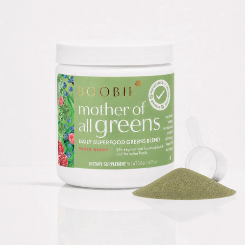 A white plastic jar of Boobie Mother of All Greens dietary supplement with a green label, shown on a white background with a small pile of the green powder and a clear scoop in front.